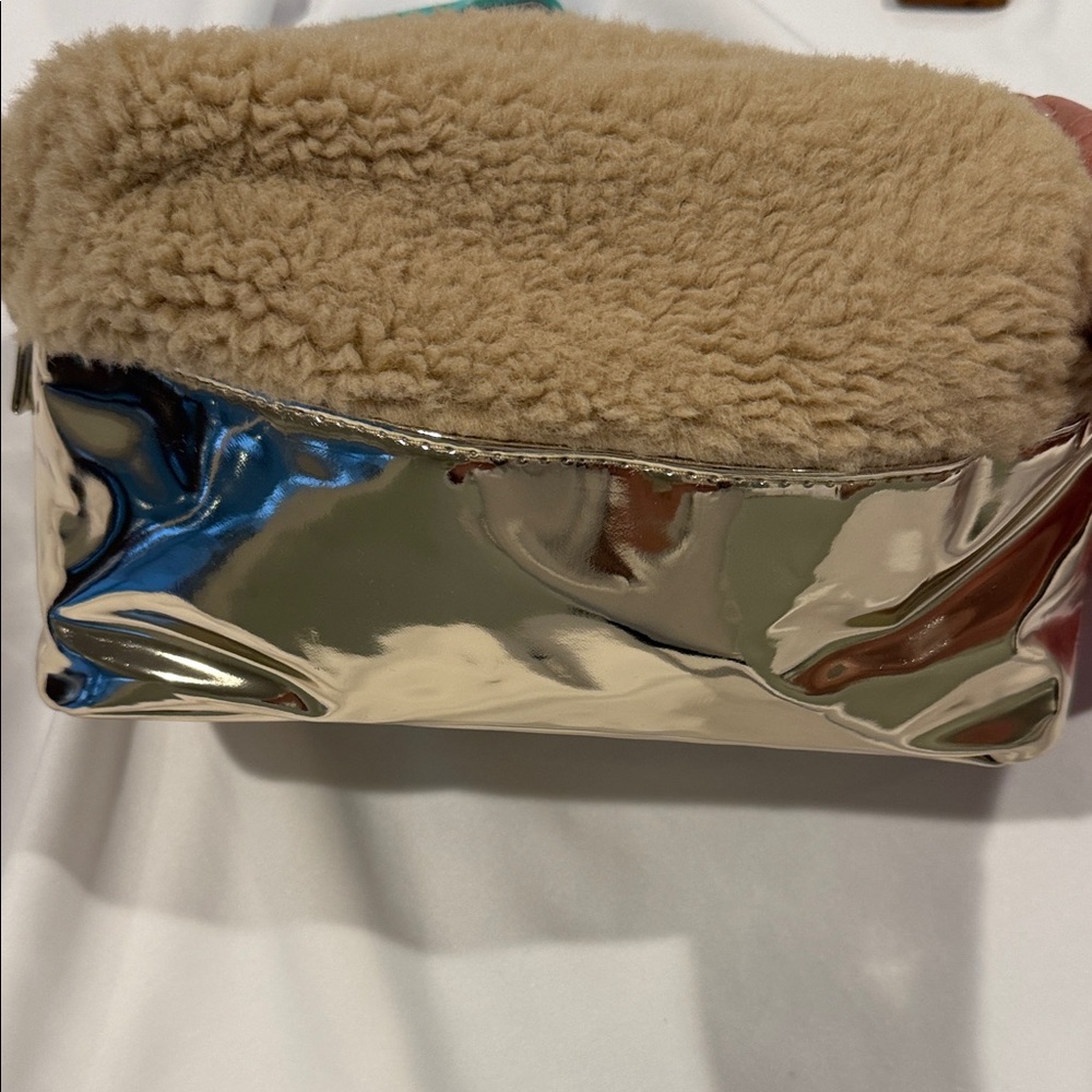 Juicy Couture Gold and Beige Cosmetic Bag on snapped on the sides to make larger